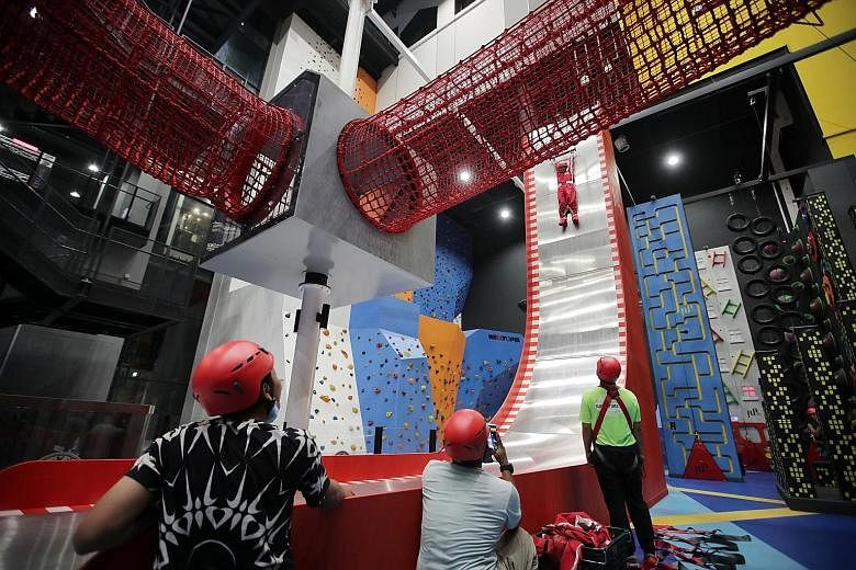 Left: The HomeTeamNS Khatib clubhouse is home to Adventure HQ, an indoor hub complete with rock climbing walls, sensory adventure trails and rope courses. Above: T-Play Khatib, a Peranakan-themed indoor playground, is also housed in the new five-stor