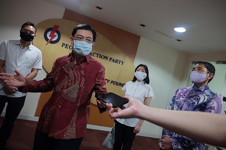 Deputy Prime Minister Heng Swee Keat speaking to reporters at the People's Action Party headquarters on Friday. He was with his East Coast GRC team - (from left) Minister of State Tan Kiat How, MPs Jessica Tan (blocked) and Cheryl Chan, and Minister 