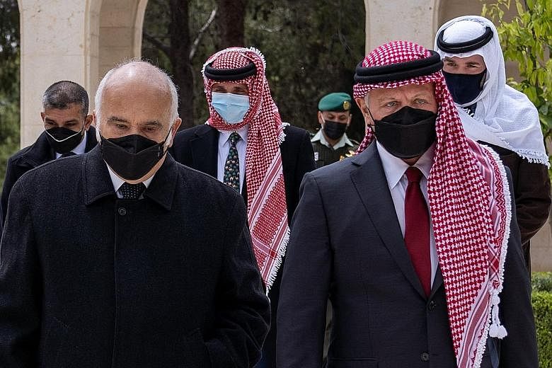 Jordan's King Abdullah (right) and Prince Hamzah (centre, behind) arriving at the Raghadan Palace on Sunday - their first joint public appearance since a crisis involving the prince rocked the kingdom last week. PHOTO: AGENCE FRANCE-PRESSE