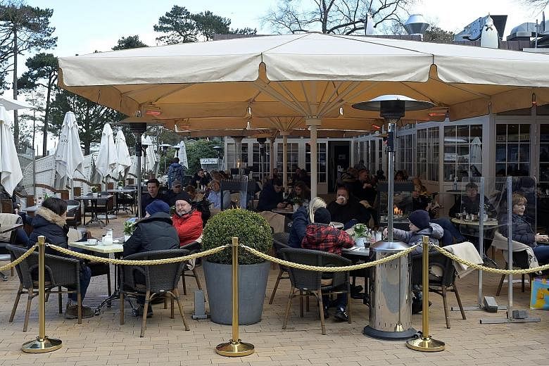 People at a restaurant in the German coastal town of Timmendorfer Strand on Monday, after outdoor catering was allowed by the authorities. But with Covid-19 infections rising rapidly in some areas in Germany, Chancellor Angela Merkel's government is 
