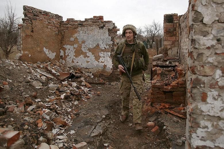 A Ukrainian serviceman patrolling near the city of Marinka, Ukraine, on Monday. The country - which applied to join the North Atlantic Treaty Organisation in 2008 - is pressing Western powers for "practical" support as it seeks to deter any new aggre