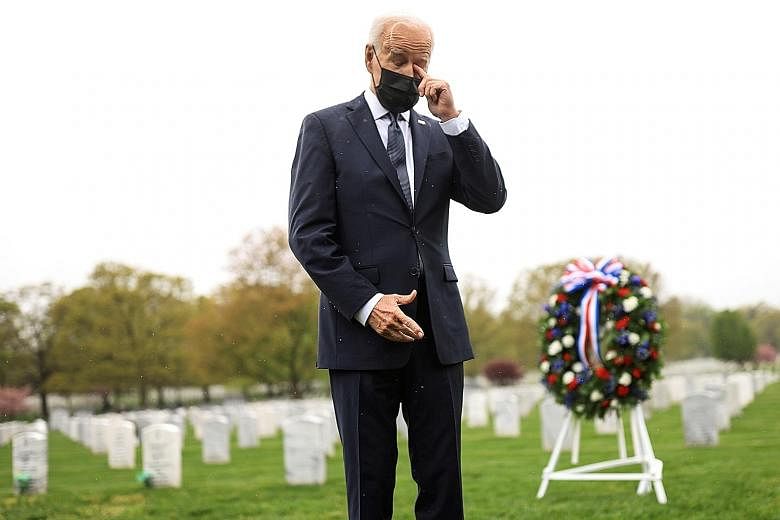 US President Joe Biden wiping away a tear during a visit to pay his respects at Arlington National Cemetery in Virginia on Wednesday. He said visiting the cemetery made him think of his son Beau, who died of cancer in 2015 after serving in Iraq. PHOT