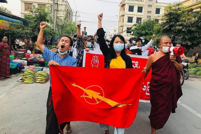 Relatives and friends at the funeral of 26-year-old Ko Ko Htet in Mandalay yesterday. He was shot dead during a protest against the Feb 1 military coup. Protesters marching against the military coup in Mandalay. They have continued taking to the stre