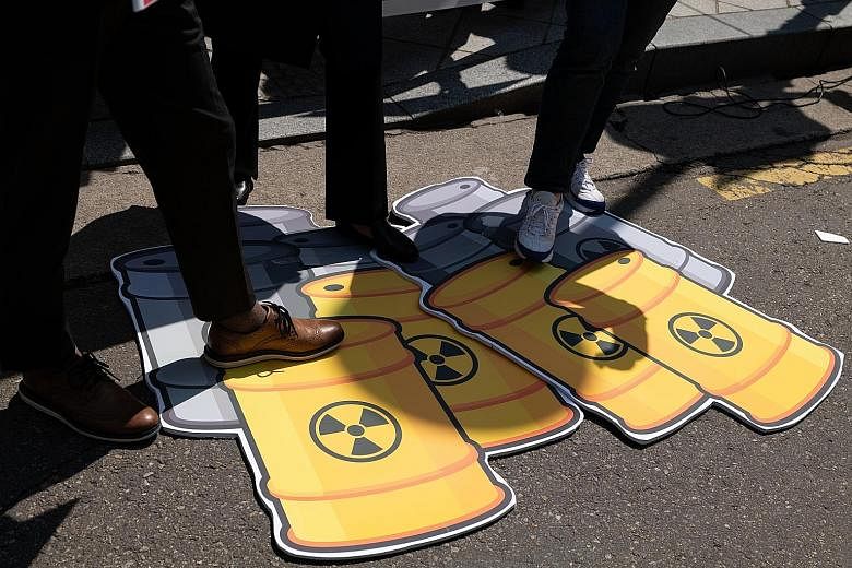 A protest by South Korea's Jinbo Party outside the Japanese embassy in Seoul on Thursday against Tokyo's decision to release treated wastewater from the stricken Fukushima Daiichi nuclear power plant into the Pacific Ocean. PHOTO: EPA-EFE