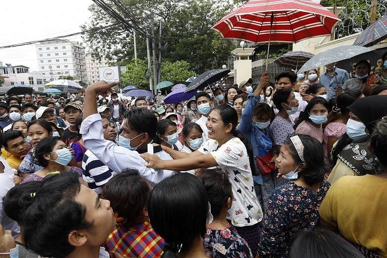 Relatives and friends milling outside a jail in Yangon yesterday for reunions with freed prisoners. While the junta has released 23,184 inmates from prisons across the country under a New Year amnesty, few if any democracy activists arrested since th