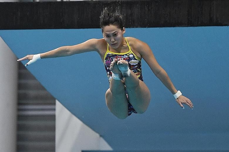Freida Lim taking a dive during training for the 10m platform at the OCBC Aquatic Centre yesterday. She is among seven divers who will compete in the Diving World Cup in Tokyo, which doubles as an Olympic qualifier. ST PHOTO: KHALID BABA