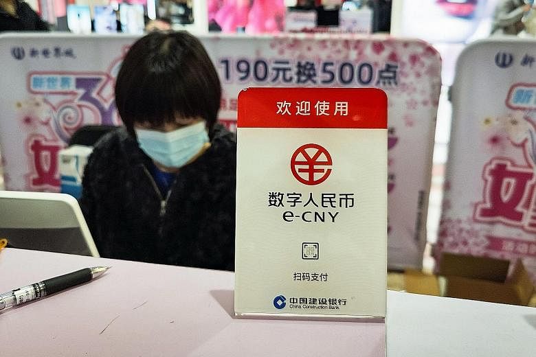 A sign for China's new digital currency being displayed at a shopping mall in Shanghai last month.