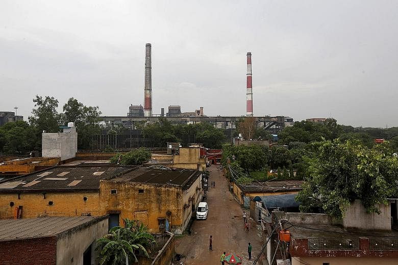 Chimneys of a coal-fired power plant seen in New Delhi. Coal still accounts for nearly three-fourths of India's annual power output.