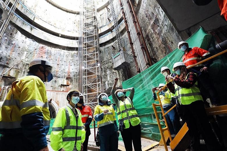 Minister for Sustainability and the Environment Grace Fu (second from left) during a visit to a project site for the second phase of construction of the Deep Tunnel Sewerage System yesterday. PHOTO: LIANHE ZAOBAO