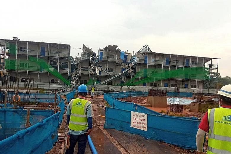 The steel structure (top) was being erected in Tengah yesterday when part of it fell onto temporary workers' quarters, which were unoccupied as they are still being built. The incident occurred at a site used for storage and prefab works supporting a