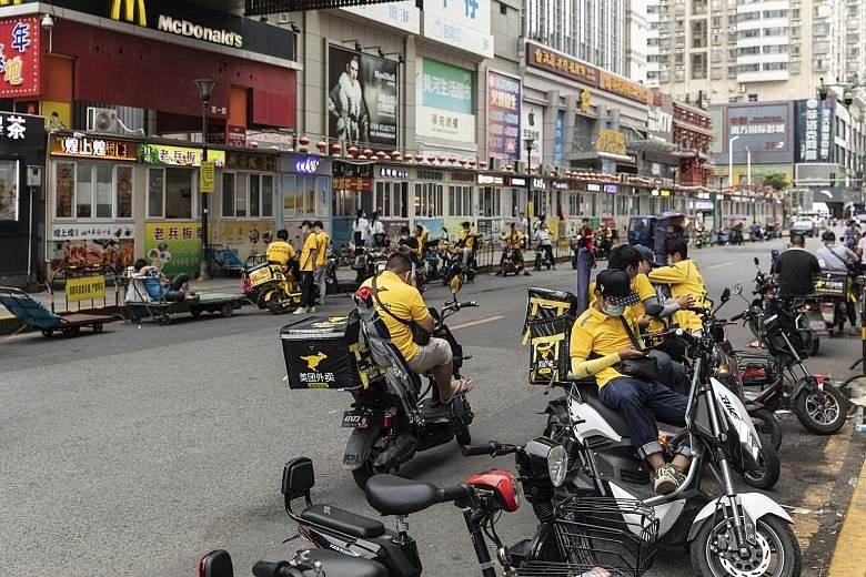 Food delivery couriers for Meituan in the Humen area of Dongguan, Guangdong province. Meituan intends to use the proceeds for technology innovations, including drone delivery and other cutting-edge technology.