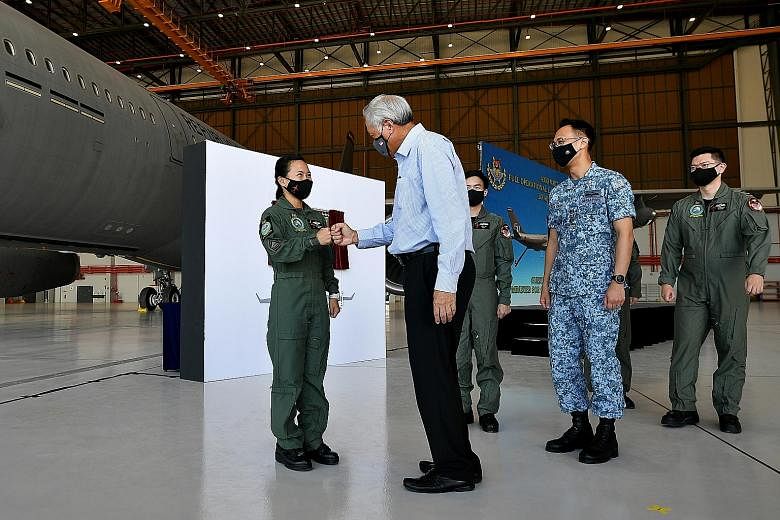 Minister for Defence Ng Eng Hen meeting First Sergeant Lim Pei Zhen of 112 Squadron yesterday when he was at Changi Air Base (East) for a ceremony to mark the air force's A330 Multi-Role Tanker Transport attaining full operational capability. The sen
