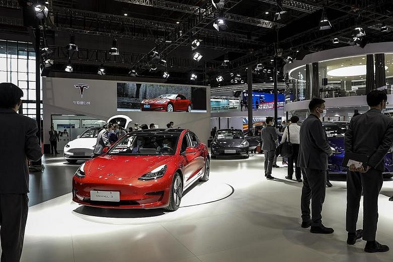 Automaker Tesla's booth at the Shanghai Auto Show in China on Monday. A woman climbed on one of Tesla's display vehicles at the show on Monday, shouting that her car's brakes had lost control. Her protest was captured by scores of onlookers who then 