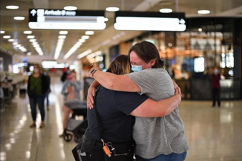 A mother (right) embracing her daughter upon her arrival from New Zealand at Sydney Airport on Monday, after Australia and New Zealand opened a quarantine-free travel bubble. Both nations are largely free of community-transmitted Covid-19 cases.