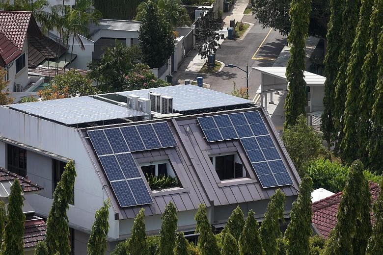 The writer says rooftop solar panels may worsen the heat island effect and increase air-conditioner use because the roof will be very hot. This may result in higher energy costs instead.
