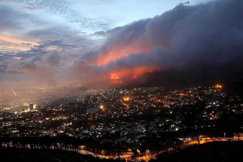 Flames fanned by strong winds after a bush fire broke out on the slopes of Table Mountain in Cape Town, South Africa, earlier this week. Developing countries like South Africa have called on developed countries to do more to help them meet their clim