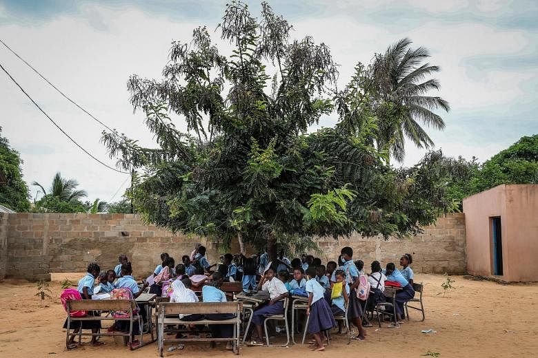 An open-air class at a school in Mozambique. The country is among dozens of nations at the crossroads of two mounting global crises that are drawing the attention of world financial institutions: climate change and debt.