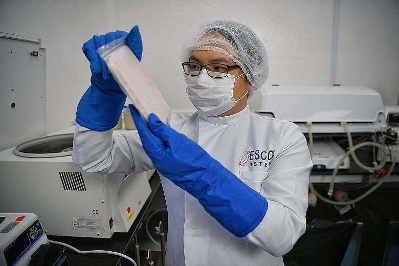 Mr Lin Xiangliang, chief executive of local biotech company Esco Aster, with a packet of cell-cultured meat. The firm is working to get a Singapore Food Agency licence for one of its labs to produce novel food ingredients. This will enable it to help