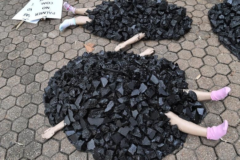 Mannequins depicting children covered in coal at an Extinction Rebellion protest in Brisbane, Australia, last week. The country has the world's fourth-largest coal reserves. PHOTO: EPA-EFE