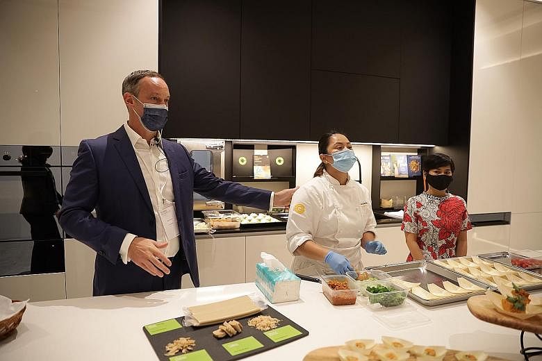 (From far left) Givaudan Taste & Wellbeing's head of regional innovation Alex Ward, chef Marilen Ingco and APAC Savoury & Snacks industry specialist Rinna Medrana showcasing plant-based protein recipes developed and cooked in-house yesterday. PHOTO: 
