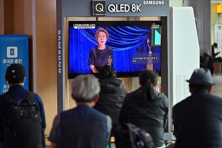 South Koreans watching in Seoul yesterday as the country's first Oscar winner for acting Youn Yuh-jung spoke at the Academy Awards. In her speech, the Best Supporting Actress winner gave a lesson on how to say her name correctly. Producers (from left