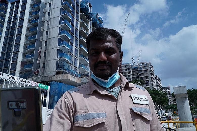 Kajima employee Gunasekar Udayakumar using the Nervotec app to scan his face through his phone's camera and check his vital signs as part of a daily check-up for employees at a construction site in Singapore.