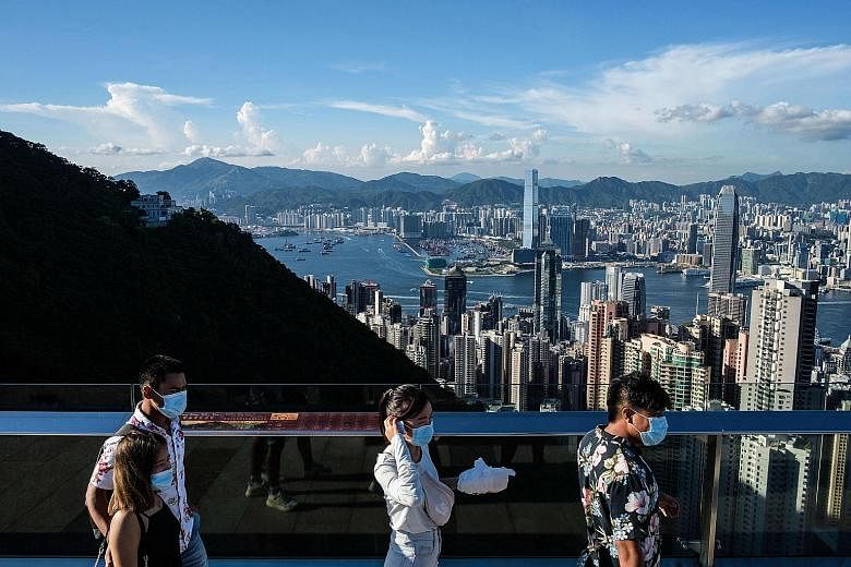 Visitors on Victoria Peak in Hong Kong last July. Those using the travel bubble must test negative for Covid-19 in a polymerase chain reaction (PCR) test taken within 72 hours before their flight.