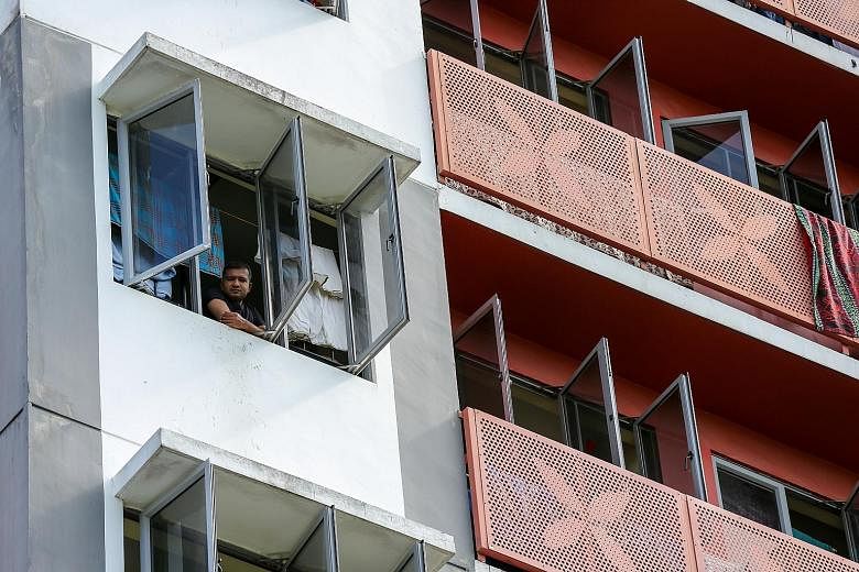 A worker at Westlite Woodlands dorm. Experts say those who have received both jabs are also less likely to spread the infection to others. Workers waiting to move out of Westlite Woodlands dormitory last Thursday. The Ministry of Health said that 17 
