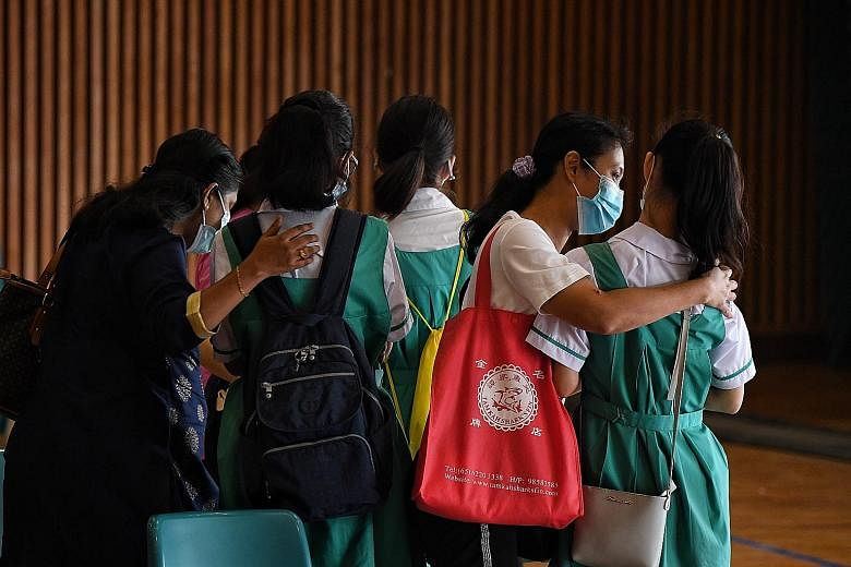 Primary 6 pupil Oh Sue-Ann, 11, who will be taking the PSLE this year under the new scoring system, which will score each standard-level PSLE subject using eight bands known as achievement levels. Zhonghua Primary School pupils after they had collect