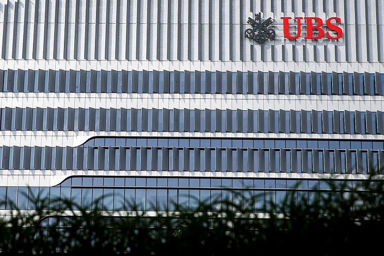 Swiss bank UBS has moved into its new office (above) at 9 Penang Road that hosts its first global cyber-fusion centre (left), and accommodates the bank's 3,000 or so staff across 400,000 sq ft (top).