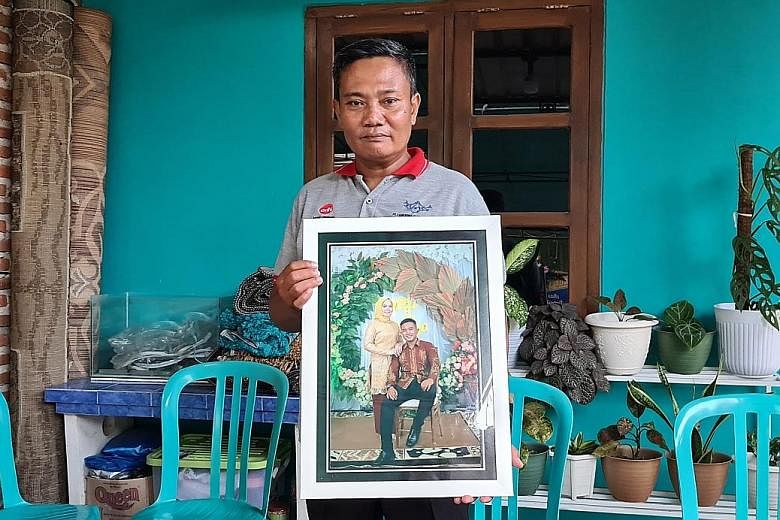 Mr Wahyudi, an army officer whose son Pandu Yudha Kusuma died in the incident, with a photo of his son and daughter-in-law. Amid the grief, he said he was also proud of his son. "For us military officers, to die on duty is an honour... That makes me 