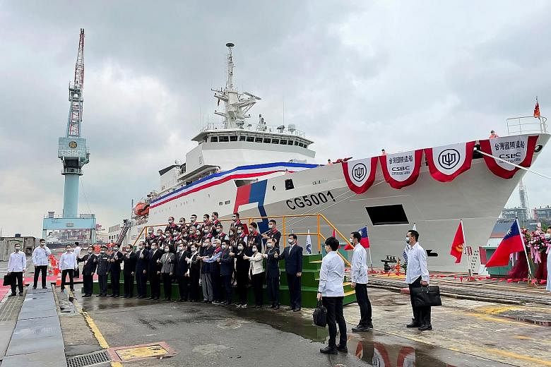 Taiwan President Tsai Ing-wen and other officials in front of the newly commissioned coast guard flagship Chiayi in the southern city of Kaohsiung yesterday.