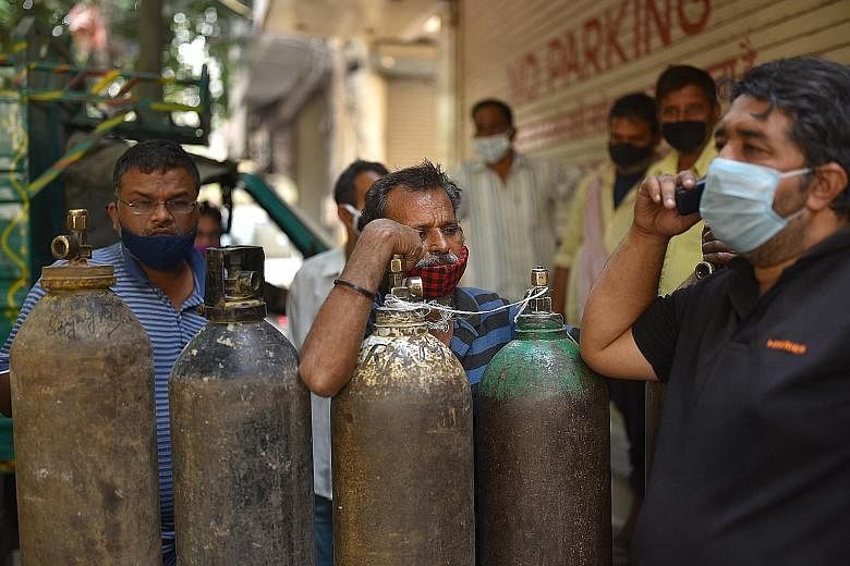 Indians waiting to fill their oxygen cylinders at an oxygen vendor in New Delhi yesterday. International support has become crucial for India as people in its cities are in desperate need of oxygen and medicines. The Indian authorities said nations i