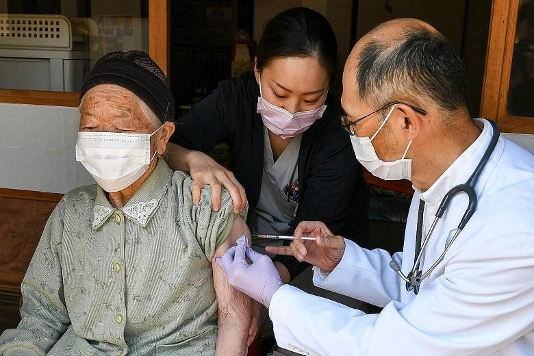 An elderly woman receiving the Pfizer-BioNTech vaccine in a village in Japan's Nagano prefecture last week. As at Tuesday, just over 3.2 million vaccine doses have been administered in the country.