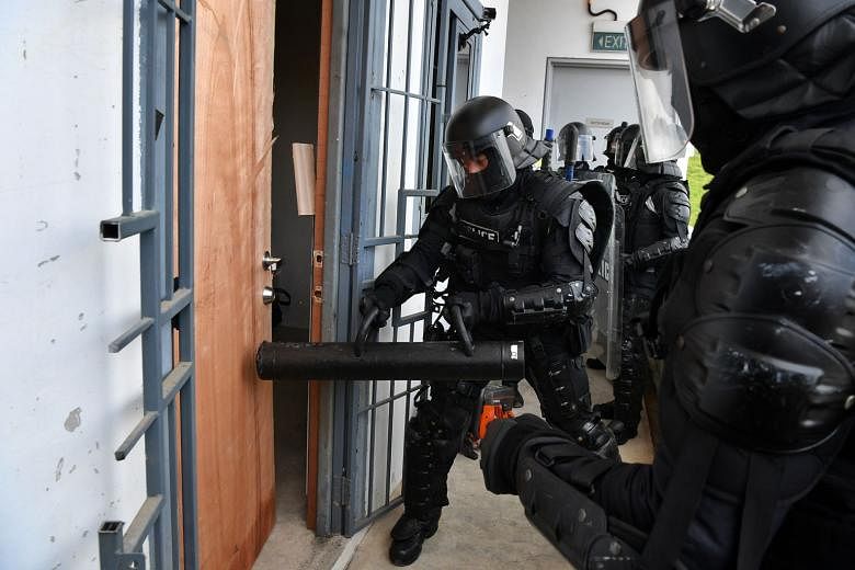 Special Operations Command officers breaching a door during a demonstration at the Home Team Tactical Centre on Tuesday.