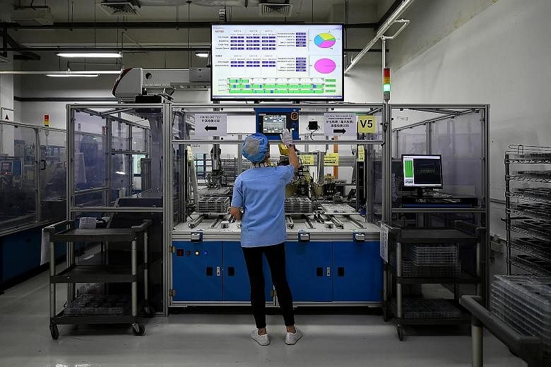 A February photo of a production operator at Sanwa Plastics. Under a plan launched in 2016, Singapore aims to transform 23 industries across manufacturing, built environment, trade and connectivity, essential domestic services, modern services and li