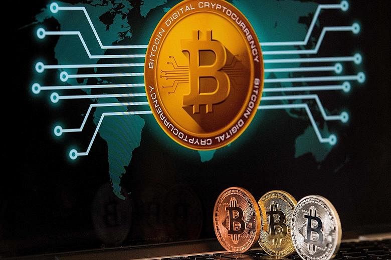 A visual representation of the digital cryptocurrency bitcoin at the Bitcoin Change shop in the Israeli city of Tel Aviv. As the coronavirus pandemic has caused a surge in online payments, some central banks are mulling over virtual currencies to riv