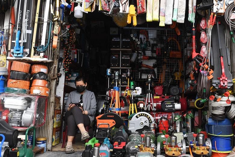 A woman waiting for customers at a shop in Hanoi, Vietnam. Pledges of foreign capital in the country rose more than 18 per cent to $13.4 billion during the first quarter of this year, from a year earlier.