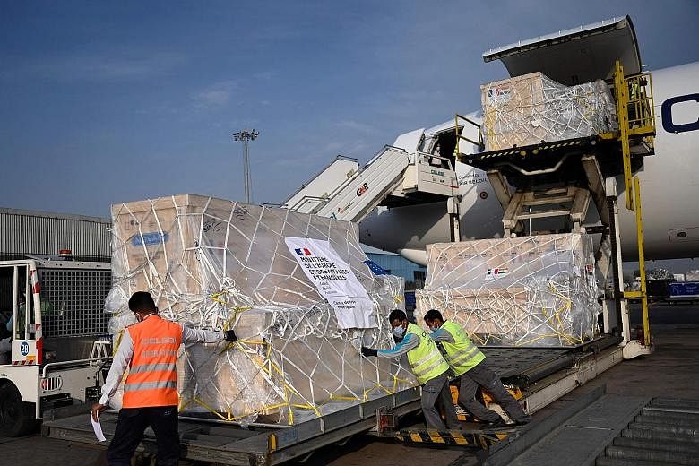 Workers unloading medical supplies from France at the Indira Gandhi International Airport in New Delhi yesterday. French Ambassador Emmanuel Lenain says his country wants to show solidarity with India.
