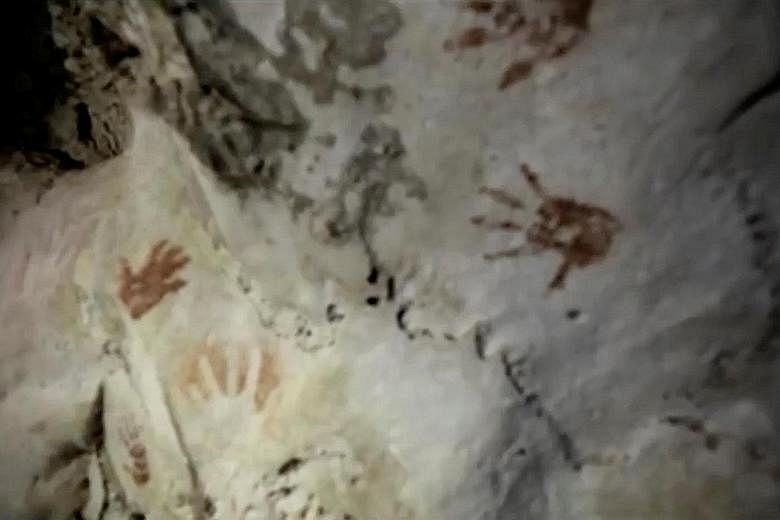 Handprints, reportedly more than 1,200 years old, on the walls of a cave in Mexico, as seen in a screengrab taken from a video. The handprints are believed to be associated with a coming-of-age ritual of the ancient Maya.