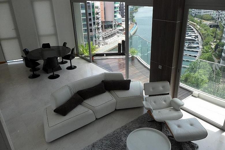 Above: Mr Nelson Loh and his wife paid $4.65 million for a 3,218 sq ft triplex penthouse at The Oceanfront in Sentosa Cove which has three bedrooms, an entertainment room and a pool. It is on the market for $4 million. Below: The couple co-own a 9,04