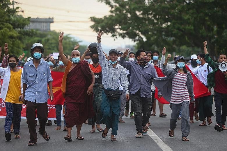 Demonstrators flashing the three-finger salute during an anti-coup protest in Myanmar's second-biggest city Mandalay on Monday. Ethnic militias have backed opposition to the junta, and the military is fighting these groups on the country's fringes. A