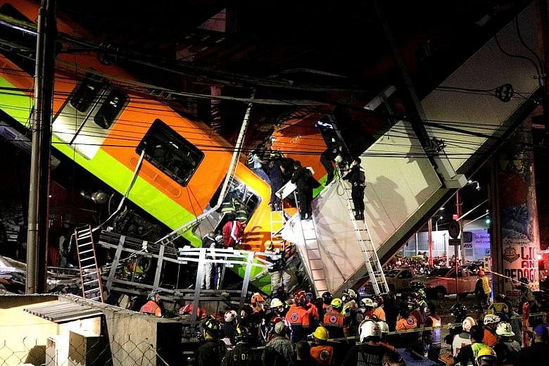 Rescuers at the site where an overpass for a rail line had partially collapsed with train cars on it at Olivos station in Mexico City on Monday.