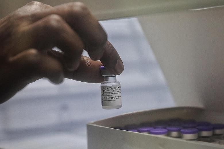 A vial of Covid-19 vaccine. Ministry of Health director of medical services Kenneth Mak said that the TTSH cluster had arisen from a viral variant, but the vaccine appears to have done relatively well against it. ST PHOTO: KEVIN LIM