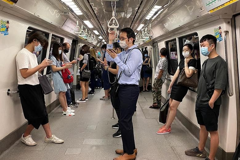 Commuters on a train travelling towards the Central Business District on Tuesday. The multi-ministry task force tackling Covid-19 has reduced the cap on employees in the workplace to 50 per cent of those able to work from home from Saturday to May 30