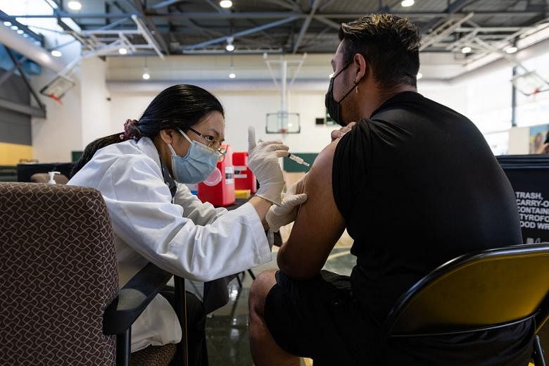 A medic administering a dose of vaccine in Washington on April 27. President Joe Biden says he wants 70 per cent of American adults to get at least one shot of the vaccine by the July 4 holiday and has made vaccinating adolescents a key part of the n