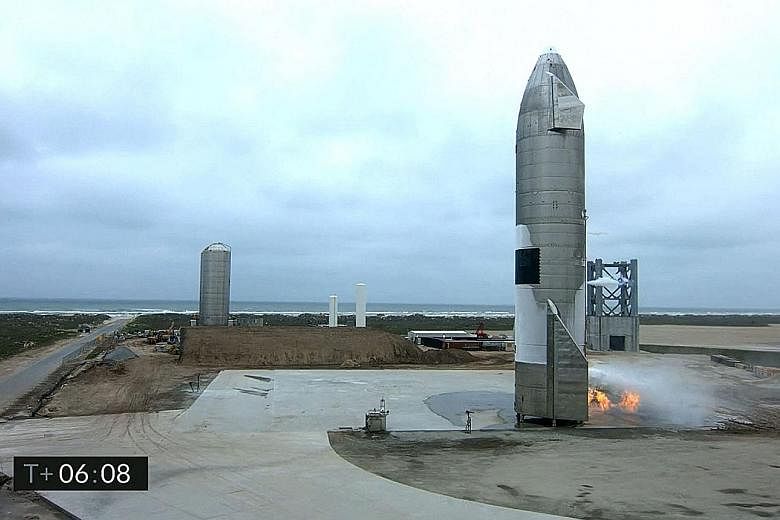 The Starship SN15 after landing in Boca Chica, Texas, on Wednesday, in a screengrab from SpaceX's live webcast. A small fire at the base of the rocket was quickly put out with water cannon, footage showed.