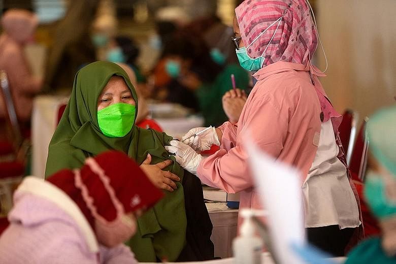 A woman getting her Covid-19 vaccine during a mass inoculation drive for teachers in Tangerang, Indonesia, late last month.