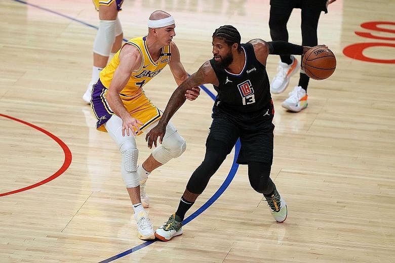 Clippers guard Paul George finding his way blocked by Lakers guard Alex Caruso. George led the Clippers' scorers with 24 points.