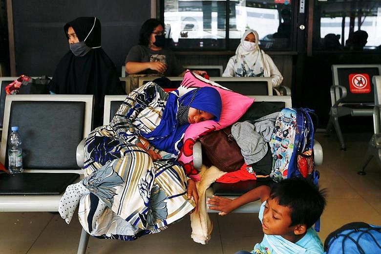 Passengers waiting at a Jakarta train station on Wednesday to return to their home towns for Hari Raya Aidilfitri, ahead of a government ban on this annual exodus from Thursday until May 17. A Ministry of Transport survey showed that 18 million plann